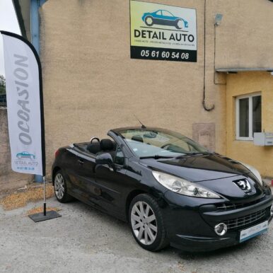 Peugeot 207 CC noire décapotable devant Detail Auto, spécialiste de la vente de véhicules d'occasion et pièces.